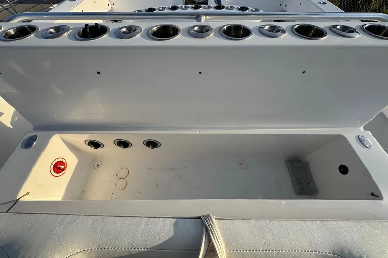Slide: The Image of Open storage compartment on 2015 SeaHunter 41 Tournament boat, featuring multiple cup holders. - 38