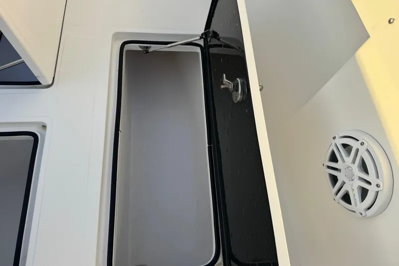 Slide: The Image of Open storage compartment on 2015 SeaHunter 41 Tournament boat with speaker detail. - 46