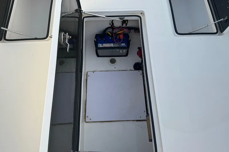 Slide: The Image of 2015 SeaHunter 41 Tournament boat compartment with battery and wiring. - 48