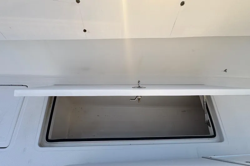 Slide: The Image of Open storage compartment on a 2015 SeaHunter 41 Tournament boat. - 52