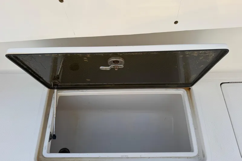 Slide: The Image of Open storage compartment on 2015 SeaHunter 41 Tournament boat. - 53