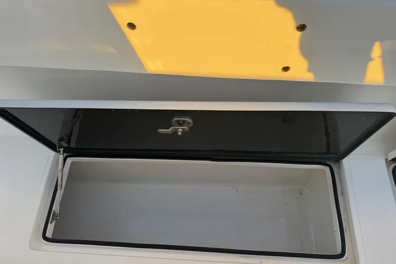 Slide: The Image of Open storage compartment on a 2015 SeaHunter 41 Tournament boat. - 54