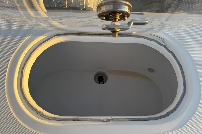 Slide: The Image of Livewell on 2015 SeaHunter 41 Tournament boat, open lid, white interior. - 57