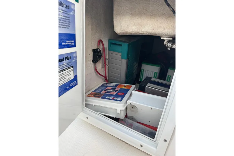 Slide: The Image of Storage compartment of 2015 SeaHunter 41 Tournament boat with equipment and manuals. - 58