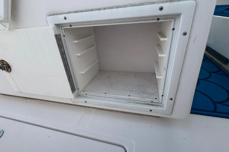 Slide: The Image of Open storage compartment on 2015 SeaHunter 41 Tournament boat. - 61
