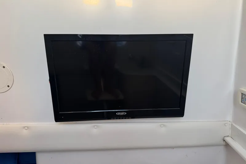 Slide: The Image of Wall-mounted Jensen TV inside 2015 SeaHunter 41 Tournament boat cabin. - 67