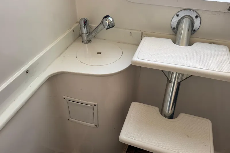 Slide: The Image of Interior of 2015 SeaHunter 41 Tournament boat with sink and ladder steps. - 70