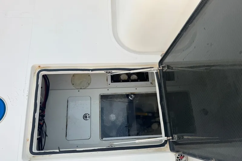 Slide: The Image of Open hatch on 2015 SeaHunter 41 Tournament boat, revealing interior compartment. - 77