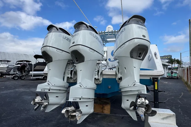 Slide: The Image of 2015 SeaHunter 41 Tournament with triple Suzuki 350 outboard engines, parked outdoors. - 80