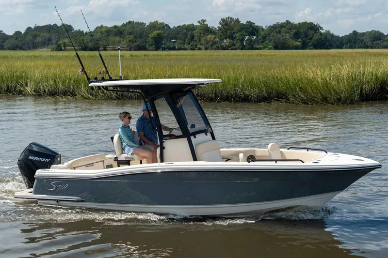 The Image of Manufacturer Provided Image: 2026 Scout 220 XSF boat cruising on a calm river with two passengers onboard. - 0
