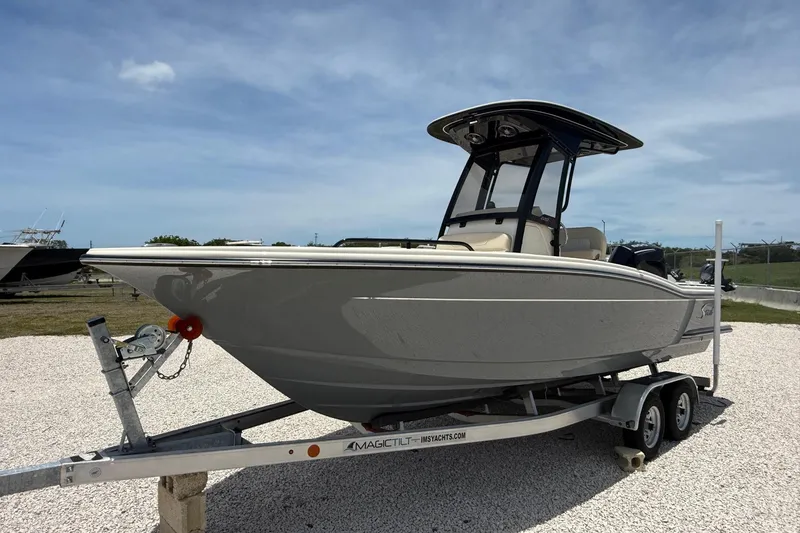 Slide: The Image of 2026 Scout 220 XSF boat on trailer under clear sky. - 10