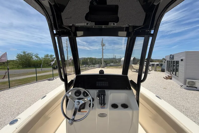 Slide: The Image of 2026 Scout 220 XSF boat cockpit with steering wheel and control panel, outdoor display. - 13