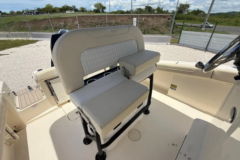 Slide: The Image of 2026 Scout 220 XSF boat interior with beige seating and steering wheel. - 15