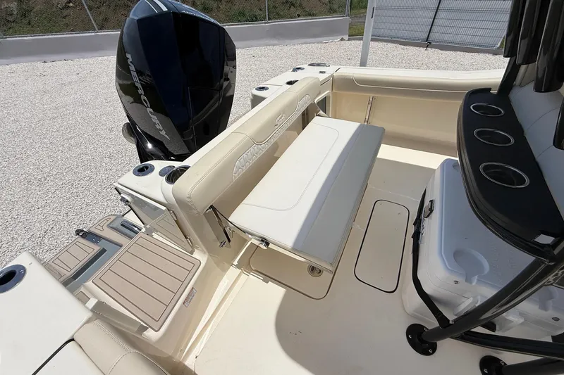 Slide: The Image of 2026 Scout 220 XSF boat interior with seating, Mercury engine, and cup holders. - 16
