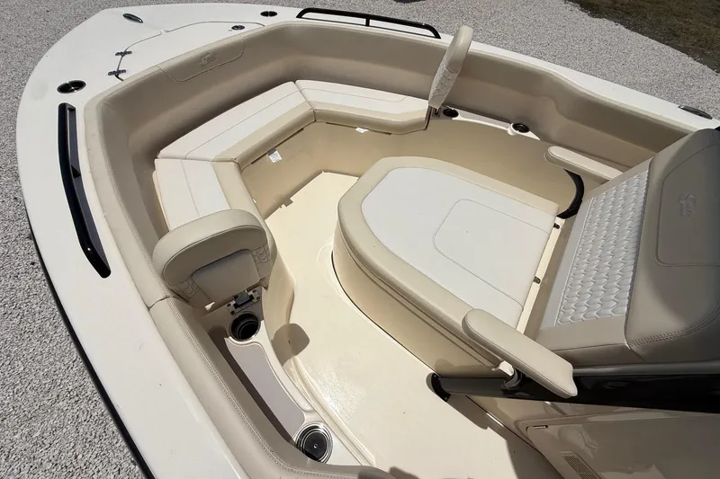 Slide: The Image of 2026 Scout 220 XSF boat interior with beige seating and spacious layout. - 19