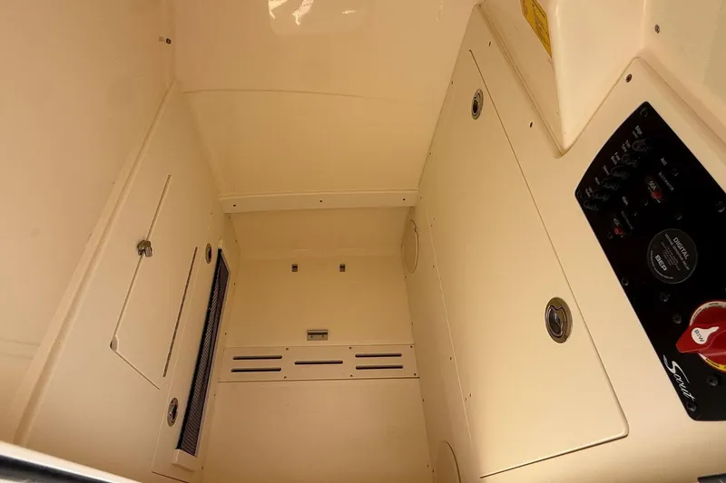 Slide: The Image of Interior view of 2026 Scout 220 XSF boat cabin with control panel and storage compartments. - 22