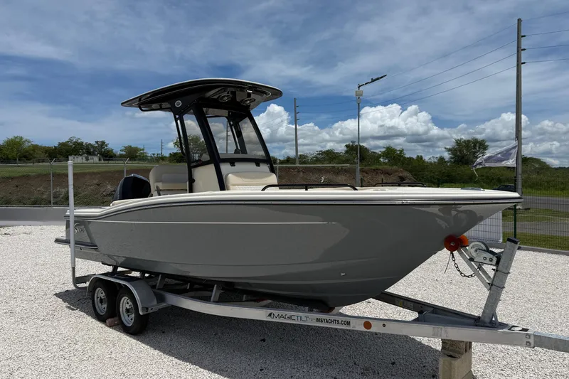 Slide: The Image of 2026 Scout 220 XSF boat on trailer under clear blue sky. - 9