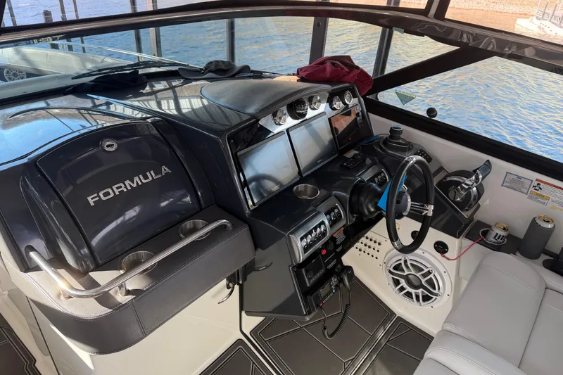 Slide: The Image of 2021 Formula 350 Crossover Bowrider I/O cockpit with modern controls and navigation displays. - 18