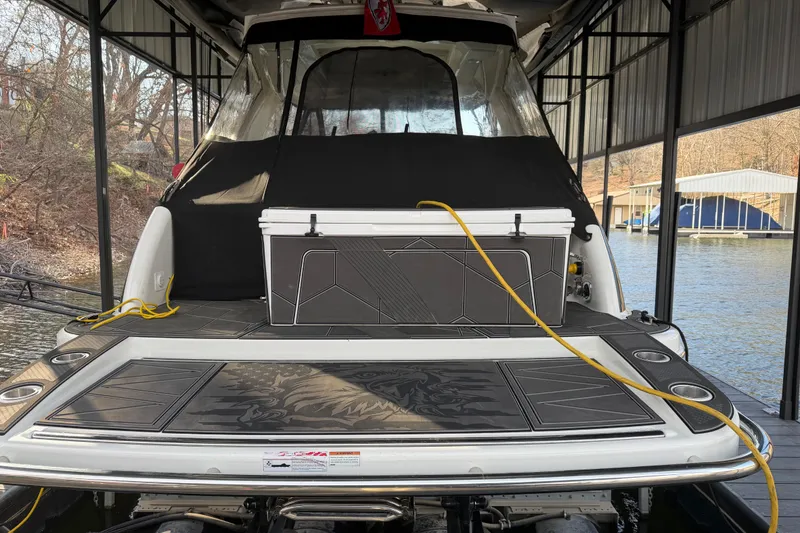 Slide: The Image of 2021 Formula 350 Crossover Bowrider I/O docked, featuring a spacious deck and cooler. - 5