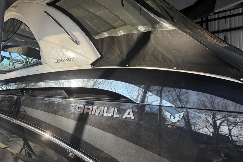 Slide: The Image of 2021 Formula 350 Crossover Bowrider I/O boat with sleek black exterior and canopy. - 6