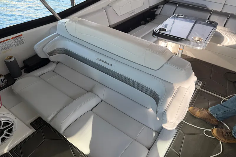 Slide: The Image of 2021 Formula 350 Crossover Bowrider I/O interior with luxurious seating and table setup. - 8