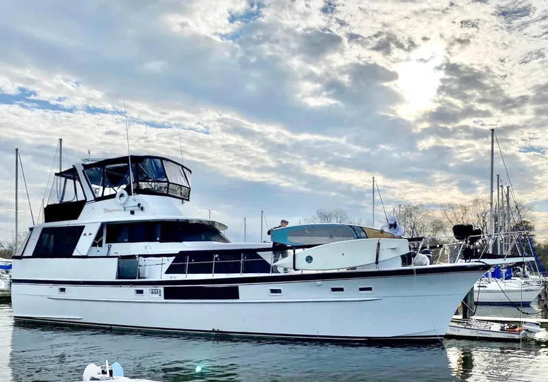The Image of 1971 Hatteras 58 Motor Yacht docked under cloudy sky. - 0