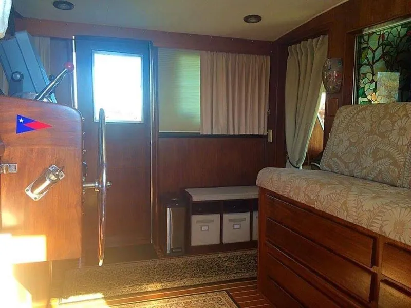 Slide: The Image of Interior of a 1971 Hatteras 58 Motor Yacht with wood paneling and helm. - 19