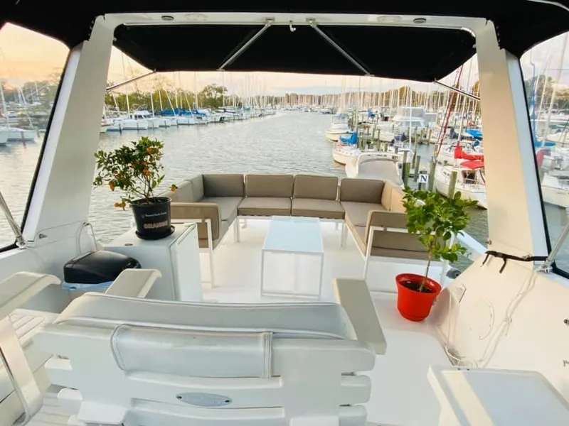Slide: The Image of 1971 Hatteras 58 Motor Yacht deck with seating area and plants. - 4