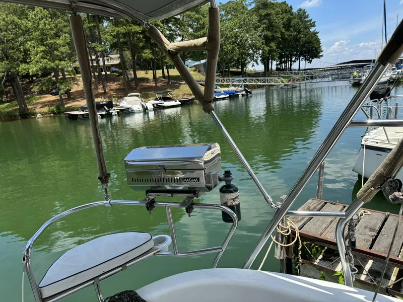 Slide: The Image of Hunter 290 sailboat from 2000 at a tranquil lakeside. - 12