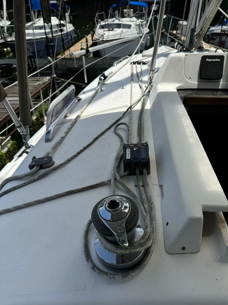 Slide: The Image of Deck of a 2000 Hunter 290 sailboat with ropes and winches. - 16