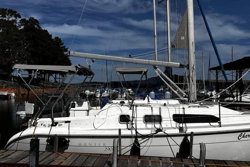 Slide: The Image of Sailboat Hunter 290, 2000 model, docked at marina under clear blue sky. - 2