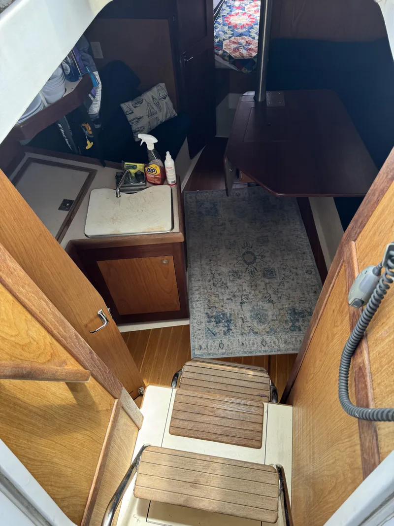 Slide: The Image of Interior of a 2000 Hunter 290 yacht with wooden furnishings. - 20