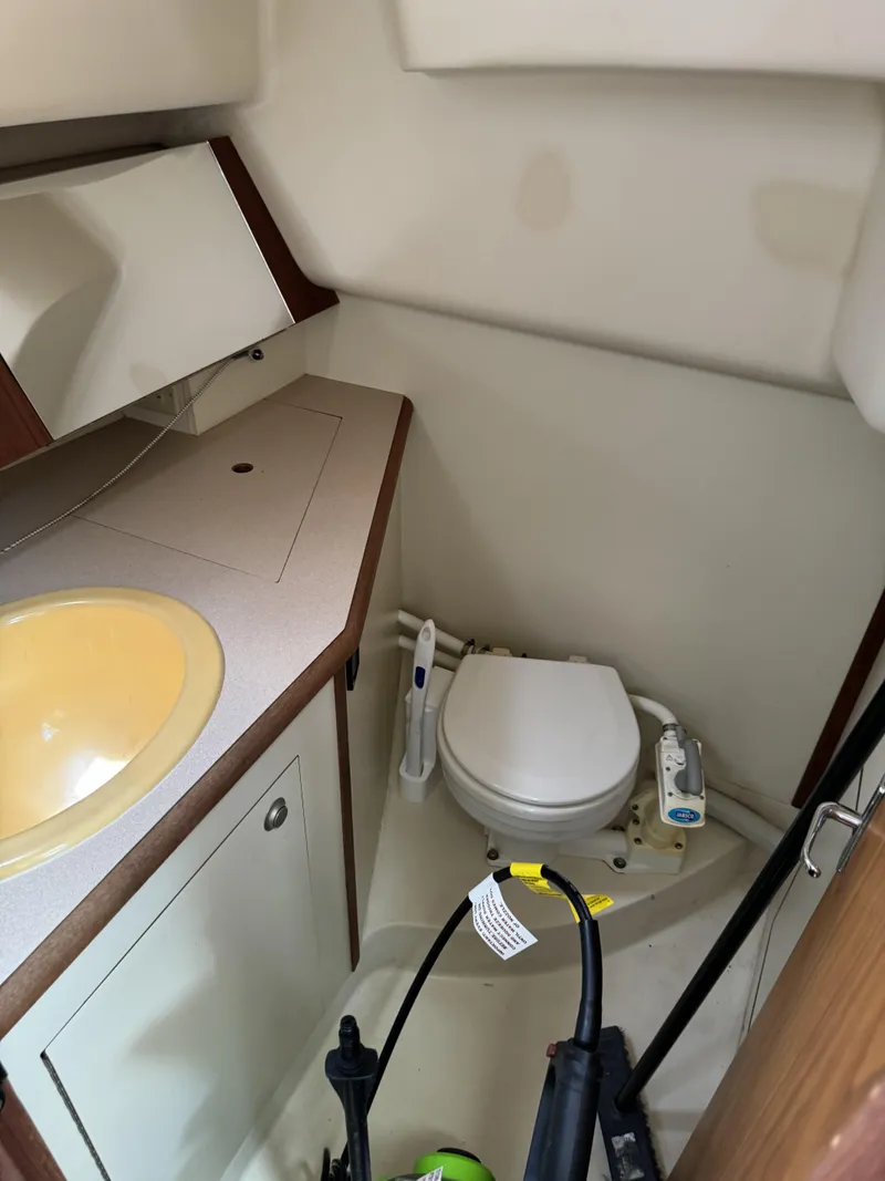 Slide: The Image of Interior of a 2000 Hunter 290 yacht with toilet and sink. - 22