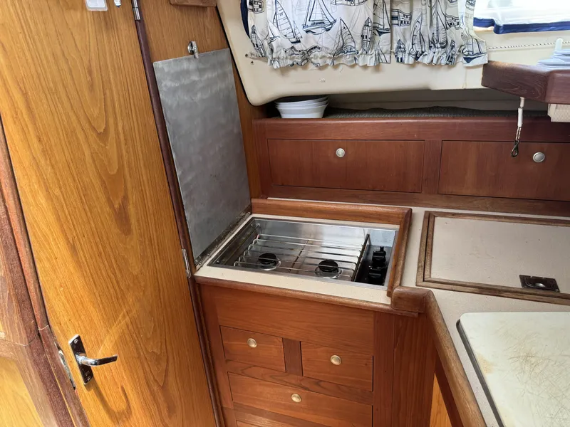 Slide: The Image of Galley area of a 2000 Hunter 290 yacht with wooden cabinetry. - 23