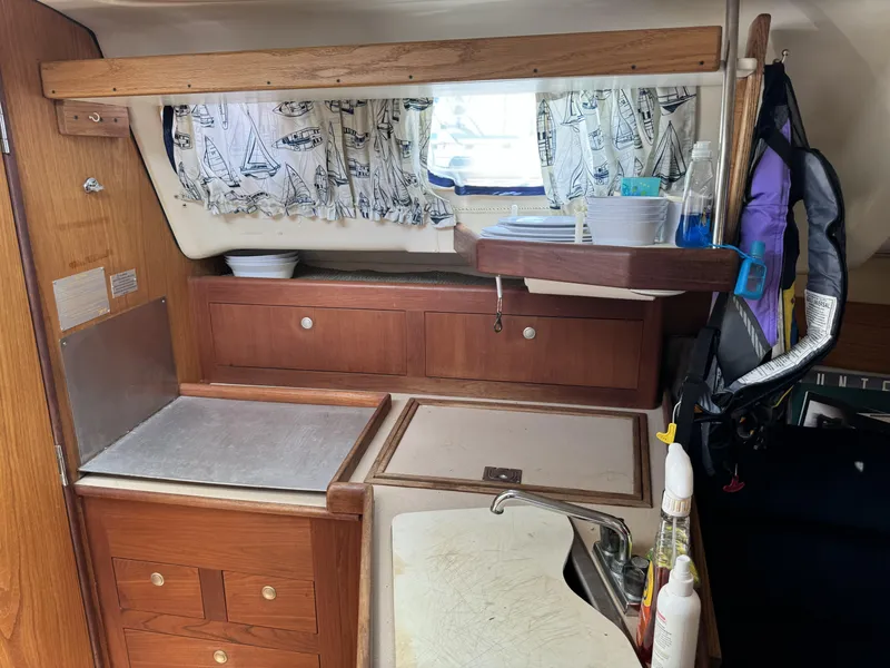 Slide: The Image of Interior of 2000 Hunter 290 yacht with kitchen and wooden cabinets. - 28