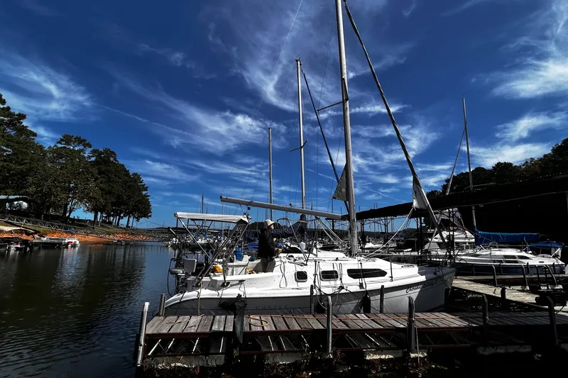 Slide: The Image of Sailboat Hunter 290, year 2000, docked under a vibrant blue sky. - 3