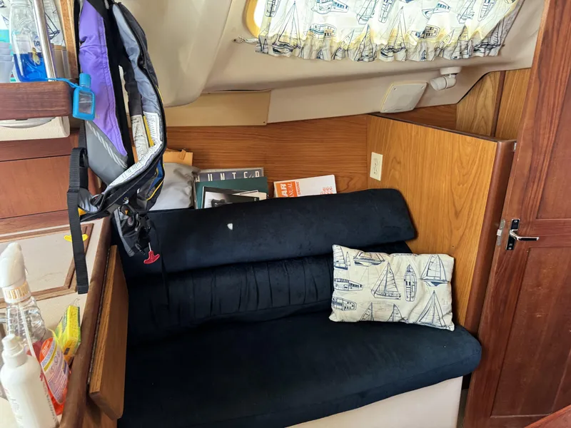 Slide: The Image of Interior of a 2000 Hunter 290 yacht with black sofa. - 30