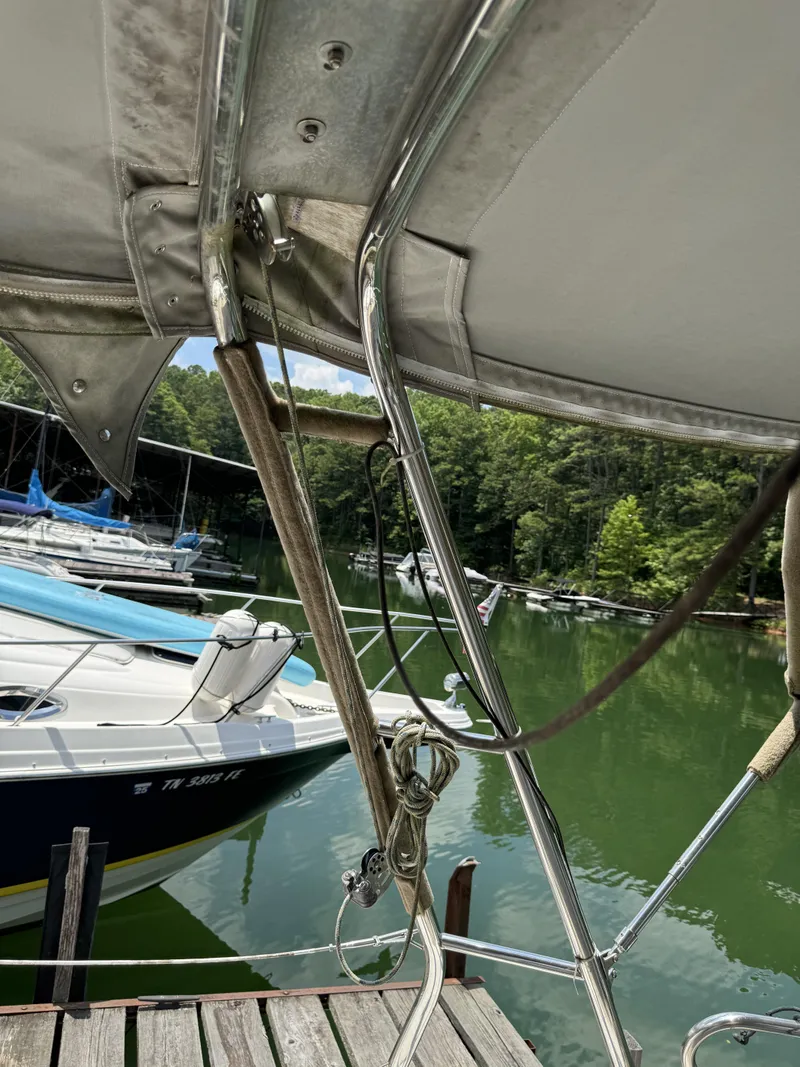 Slide: The Image of 2000 Hunter 290 sailboat docked, surrounded by water and trees. - 41