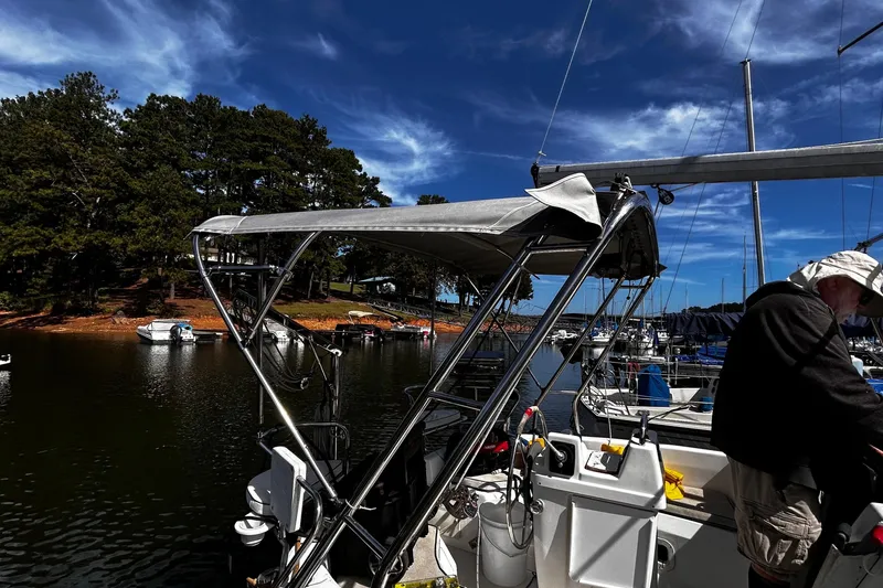 Slide: The Image of Sailboat docked at marina, Hunter 290 model, 2000, with scenic lake and trees. - 6