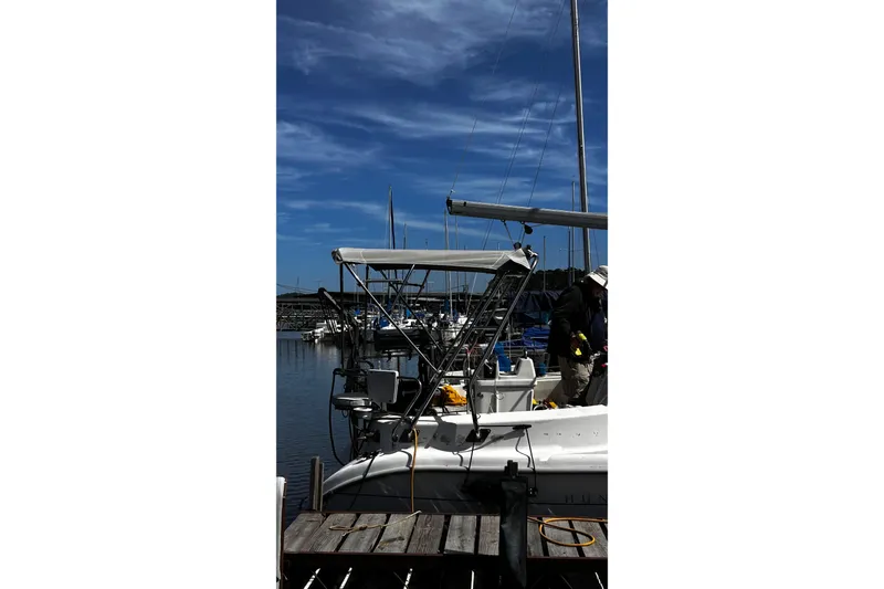 Slide: The Image of Hunter 290 sailboat from 2000 docked at marina under clear blue sky. - 7
