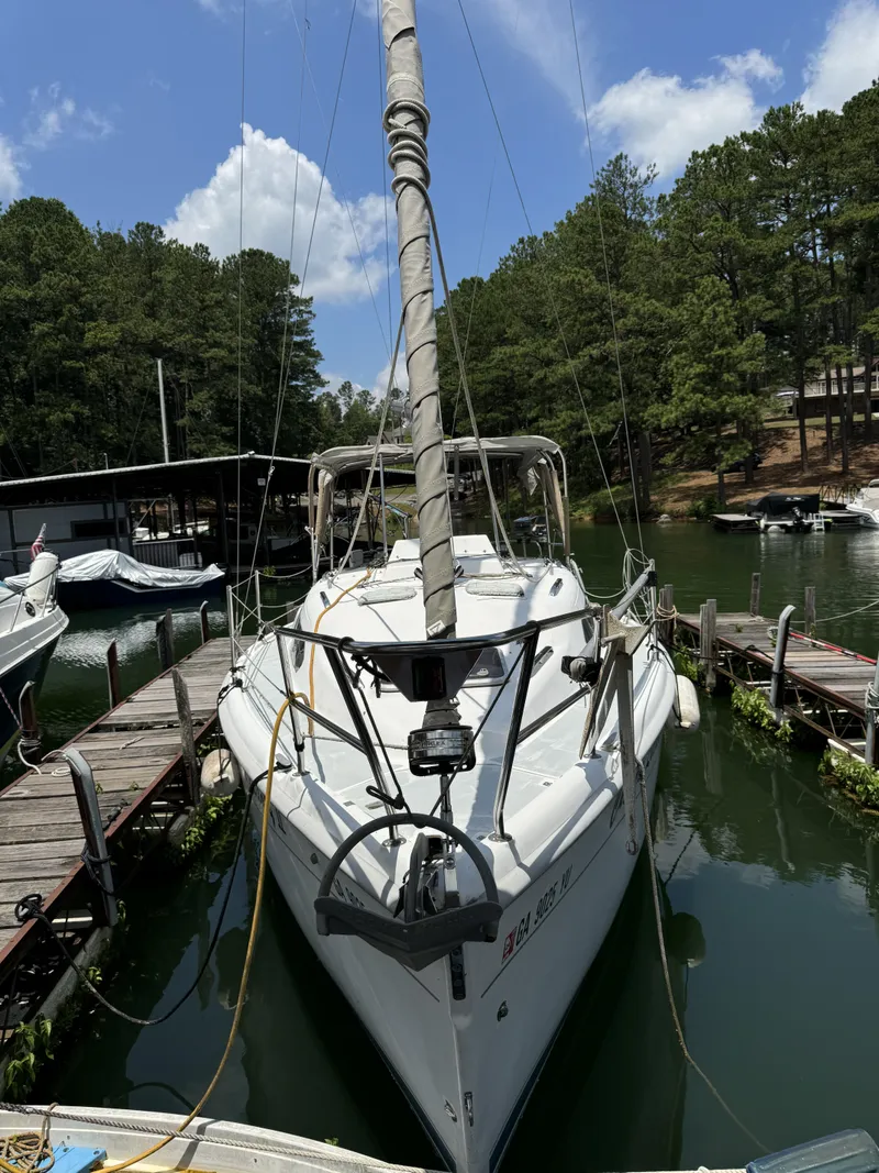 Slide: The Image of 2000 Hunter 290 sailboat docked, surrounded by trees. - 8
