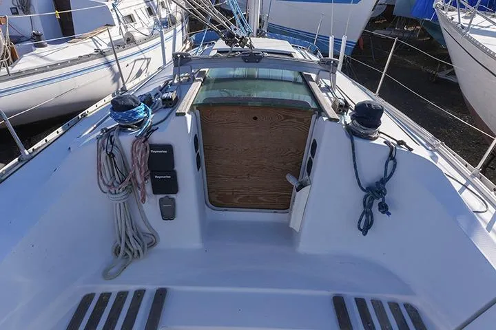 Slide: The Image of 1991 Beneteau First 310 sailboat cockpit with ropes and winches, docked in a marina. - 13