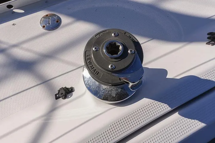 Slide: The Image of Winch on 1991 Beneteau First 310 sailboat deck, featuring Lewmar branding. - 20