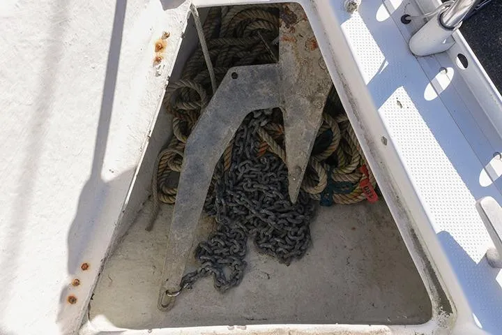 Slide: The Image of Anchor and ropes in the storage compartment of a 1991 Beneteau First 310 sailboat. - 21