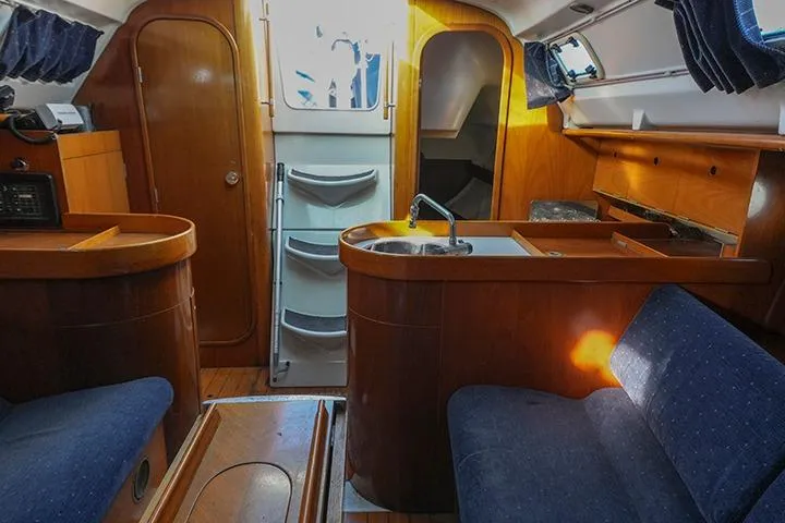 Slide: The Image of Interior of 1991 Beneteau First 310 sailboat with wooden cabinetry and seating. - 23