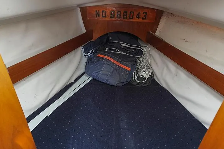 Slide: The Image of Interior view of 1991 Beneteau First 310 sailboat cabin with storage bag and ropes. - 29