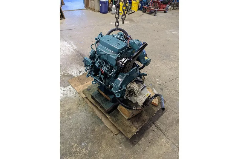 Slide: The Image of Engine of a 1991 Beneteau First 310 sailboat on a workshop floor. - 32