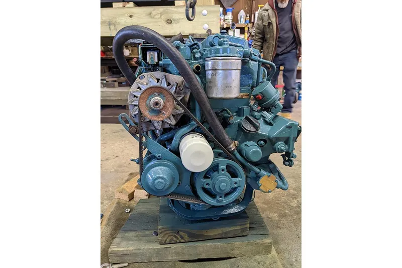 Slide: The Image of Engine of a 1991 Beneteau First 310 sailboat, displayed in a workshop setting. - 34