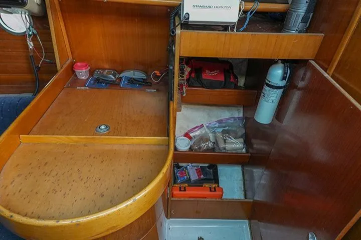 Slide: The Image of Interior of a 1991 Beneteau First 310 sailboat with storage compartments and equipment. - 35