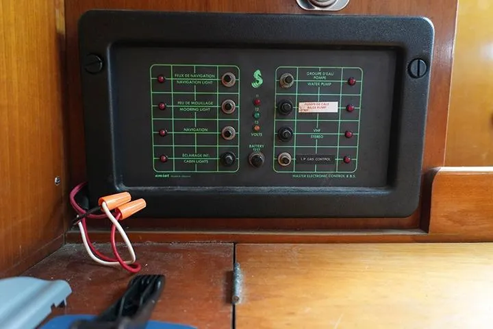 Slide: The Image of Control panel of a 1991 Beneteau First 310 sailboat, featuring navigation and utility switches. - 36